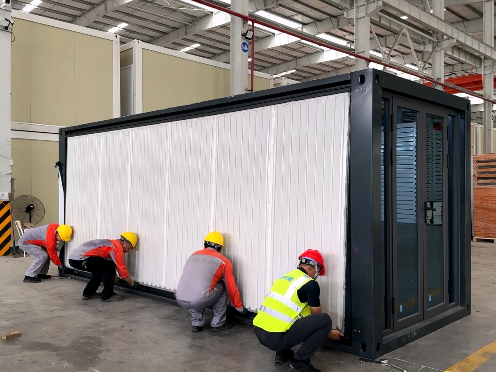 Expandable container house being unfolded and prepared for installation