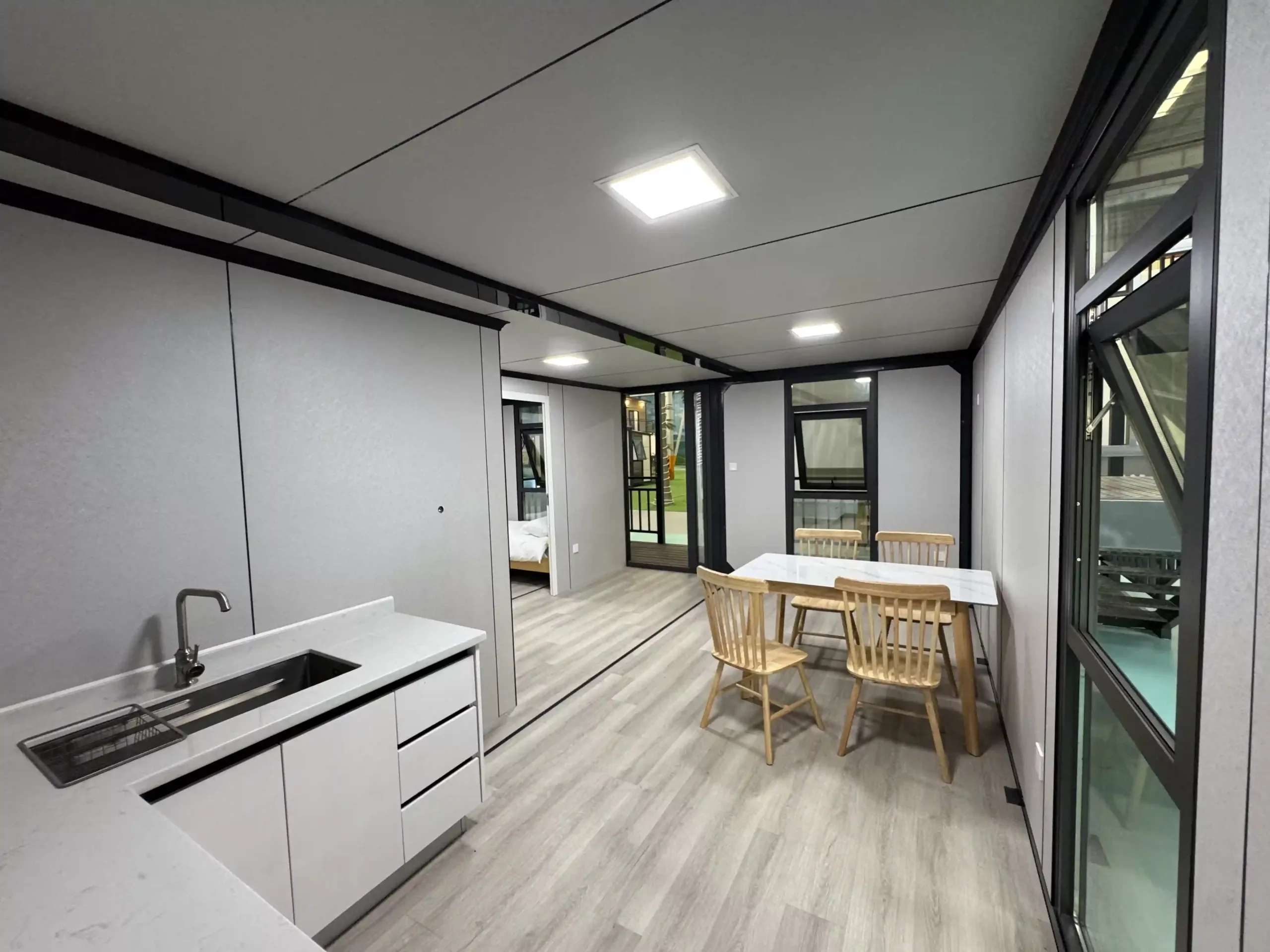 Functional kitchen and dining area inside GS Housing expandable container home, combining style and efficiency.
